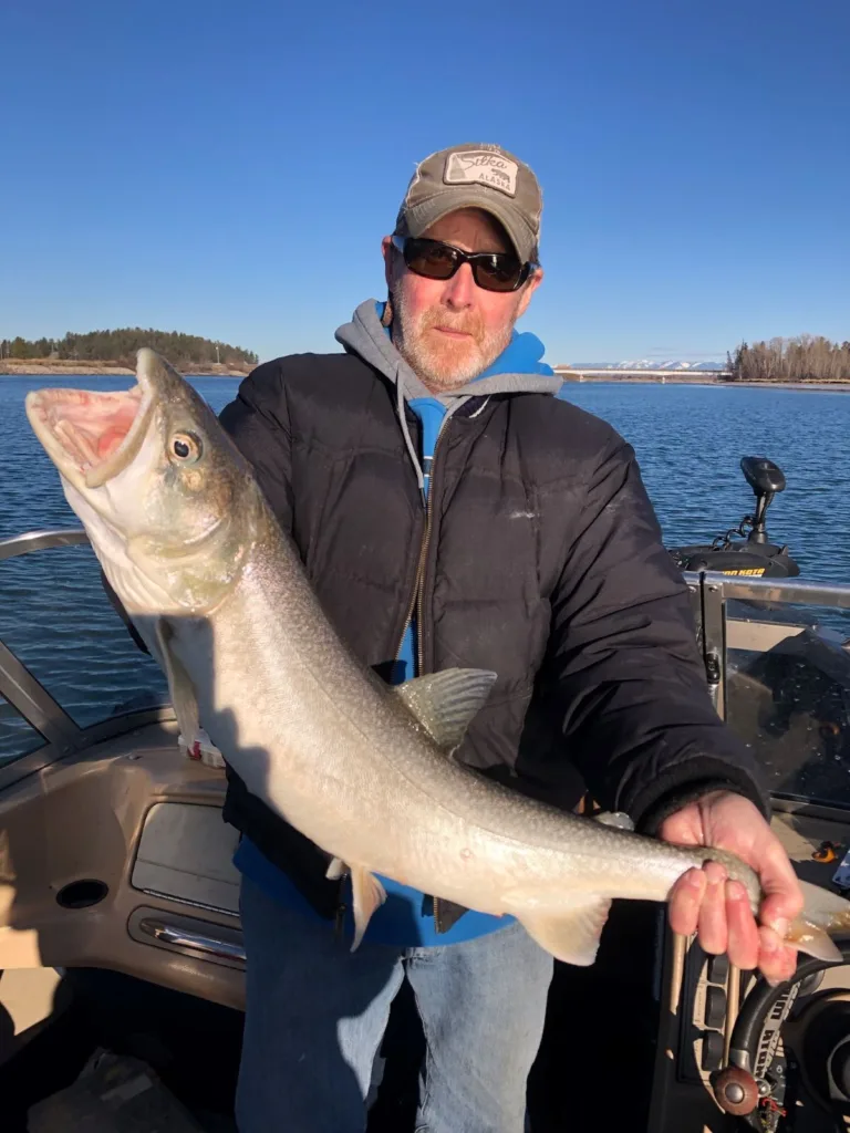 holding a lake trout on Flathead Lake